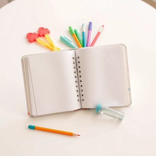 Open magic water drawing book with a water pen and blank pages ready for kids’ mess-free drawing